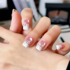 Snow Blossom pink snowflake French tip press-on nails
